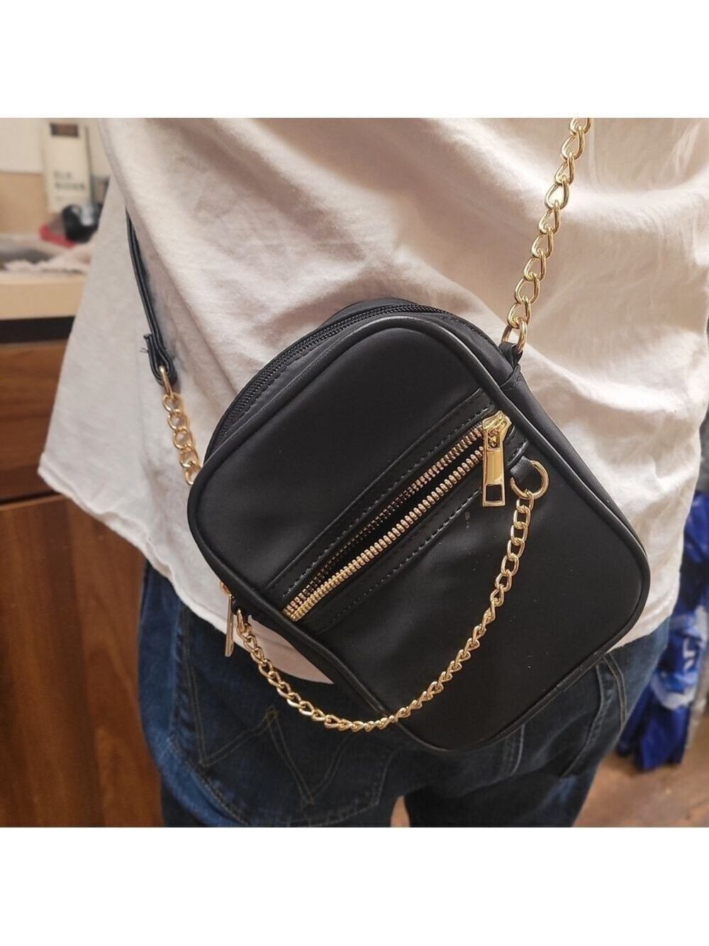 Elegant Black Crossbody Bag with Gold Accents